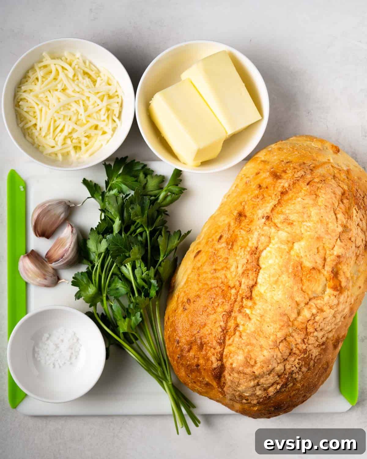 all the ingredients needed to make this recipe: cheese, butter, garlic, parsley, bread, salt