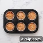 Carrot Cake Cupcakes from Box Mix — Moist, Spiced & Quick 7 carrot cake cupcake batter in a cupcake tin.