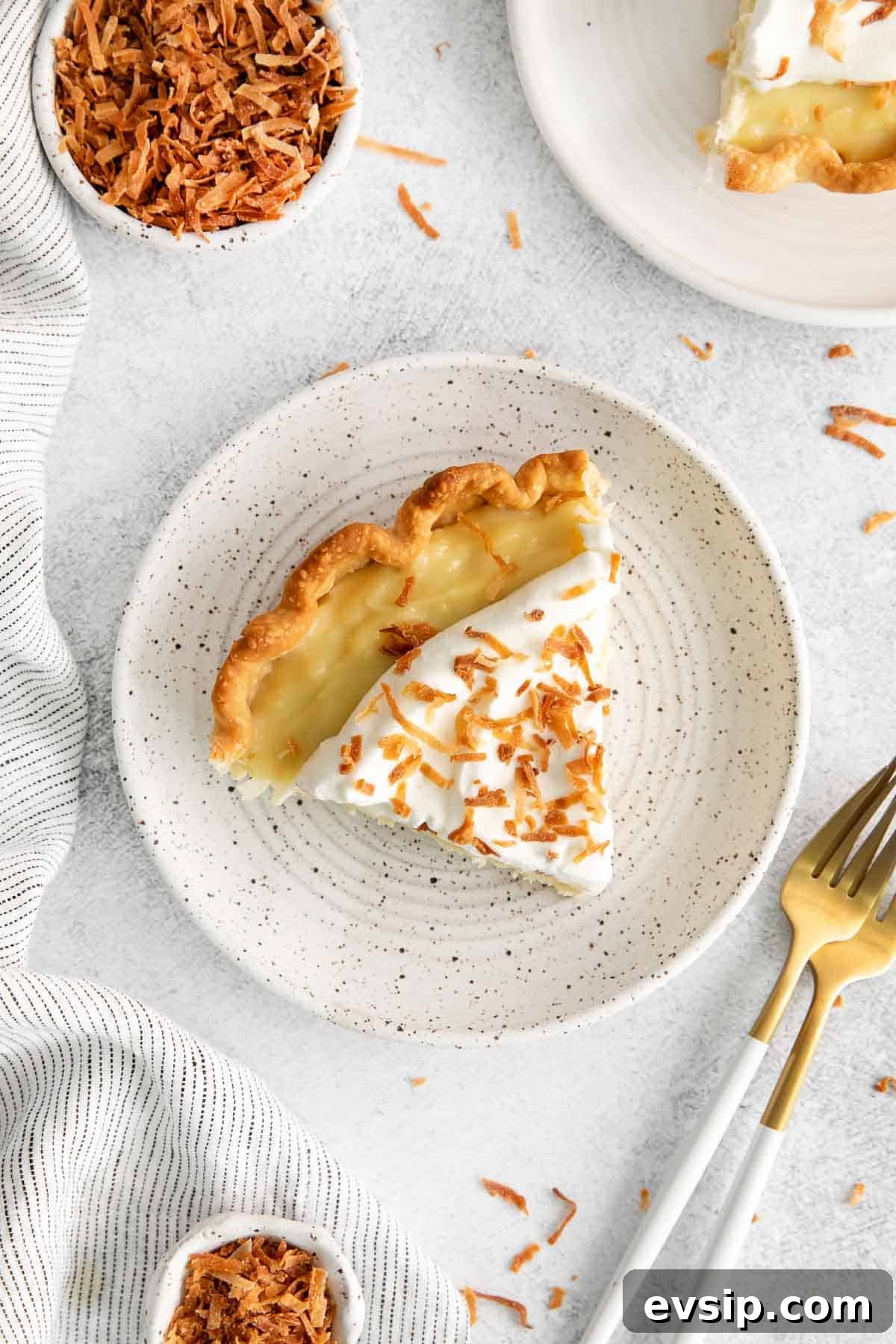 An overhead look at a slice of coconut cream pie on a plate
