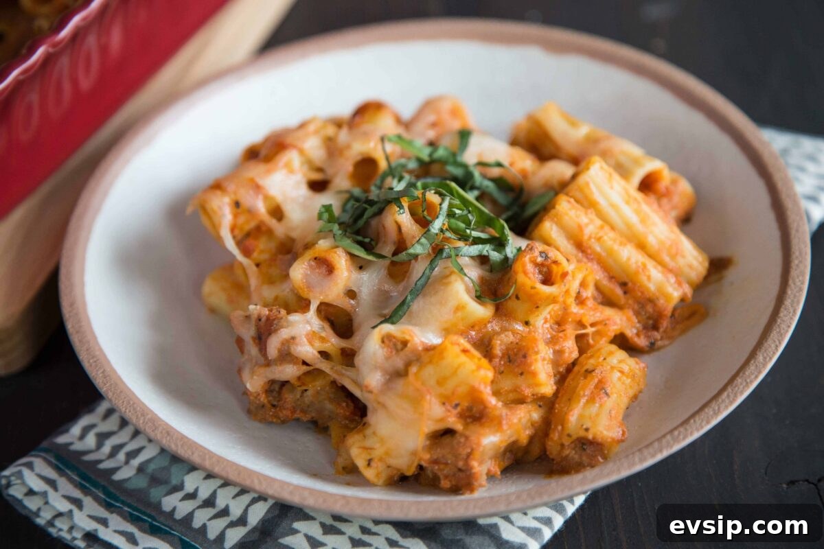 bowl of baked ziti topped with fresh basil.