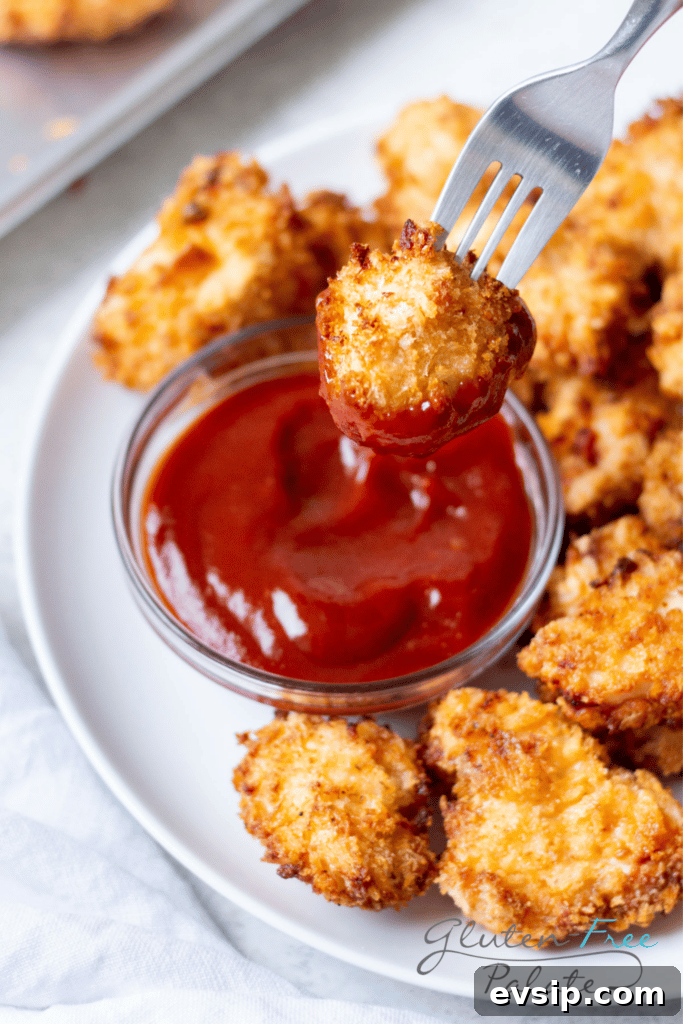 Irresistible Gluten-Free Brunch Recipes You’ll Crave Again 12 A plate of breaded gluten-free chicken nuggets. One is being dipped into a small bowl of ketchup.