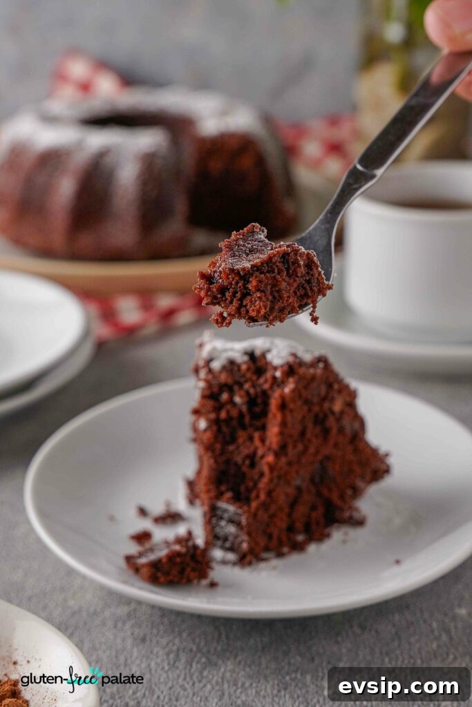 Irresistible Gluten-Free Brunch Recipes You’ll Crave Again 15 A slice of Gluten-free chocolate bundt cake on a white plate with a fork taking a bite.