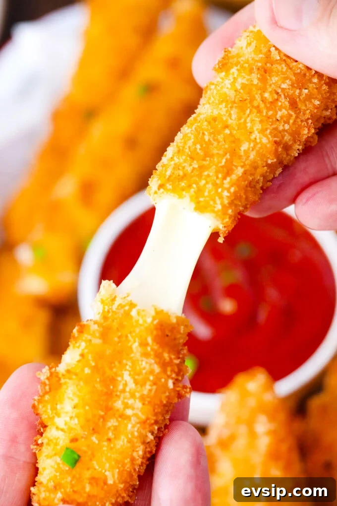Pulling a crispy fried cheese stick.