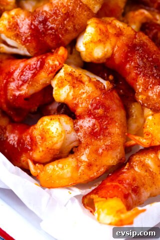Close shot of bacon wrapped shrimp with brown sugar on a tray.