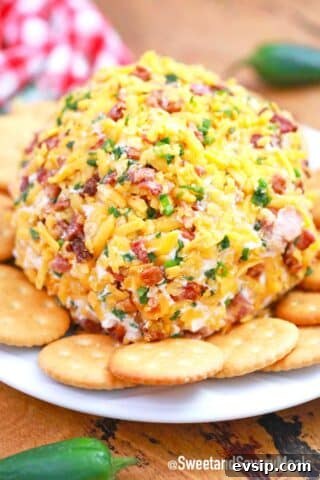 jalapeno popper cheese ball on a plate with crackers