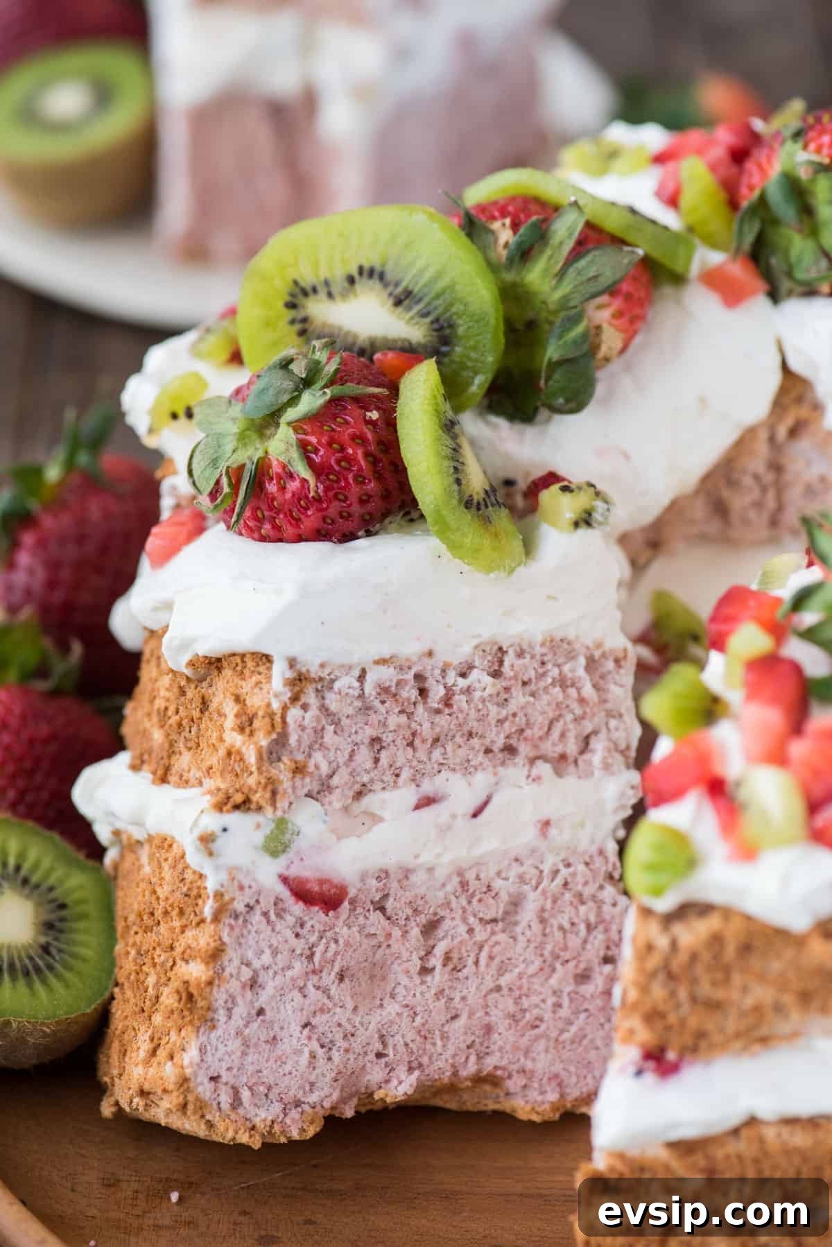 Light and Fluffy Strawberry Angel Food Cake Recipe 6 slice of strawberry angel for cake with whipped cream, strawberries and kiwi