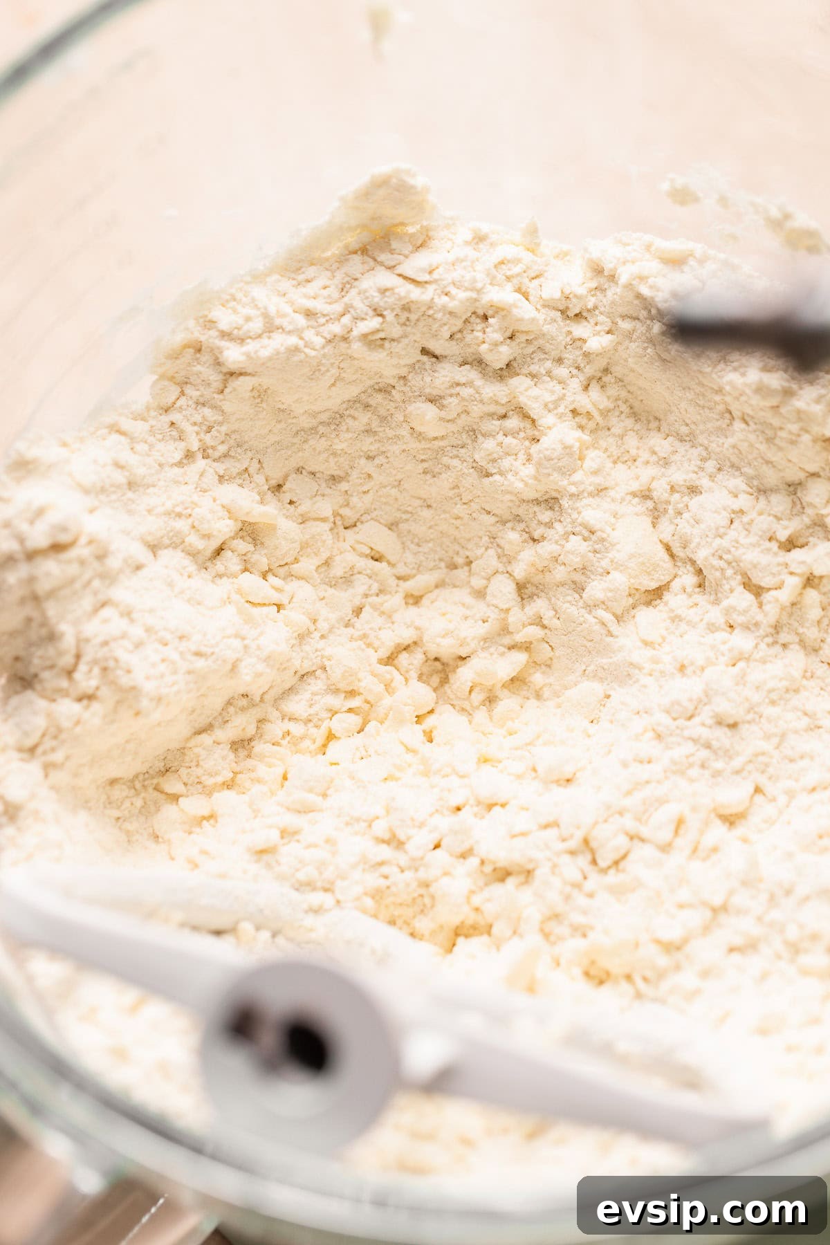 Flour and butter mixed to pea sized bits in a mixer bowl for the pie dough.