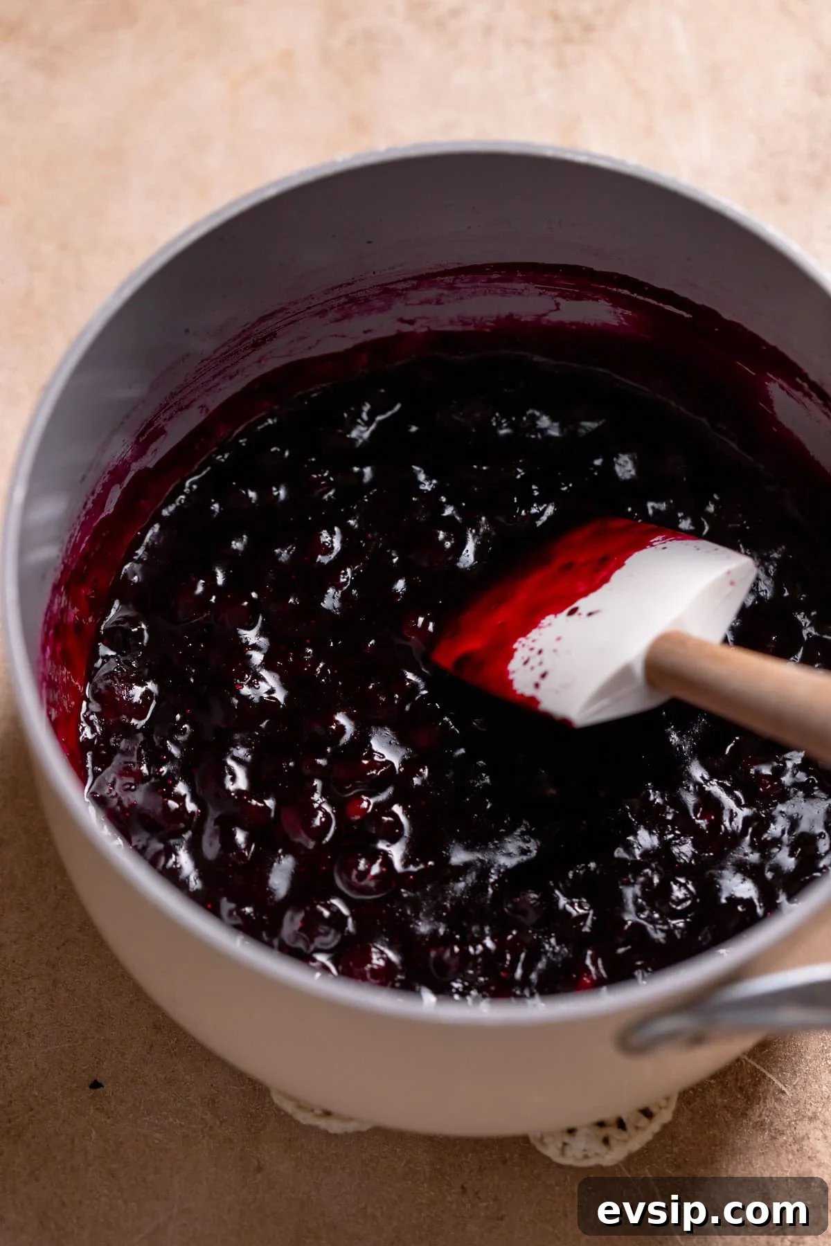 Blueberry pie filling in a white pot.