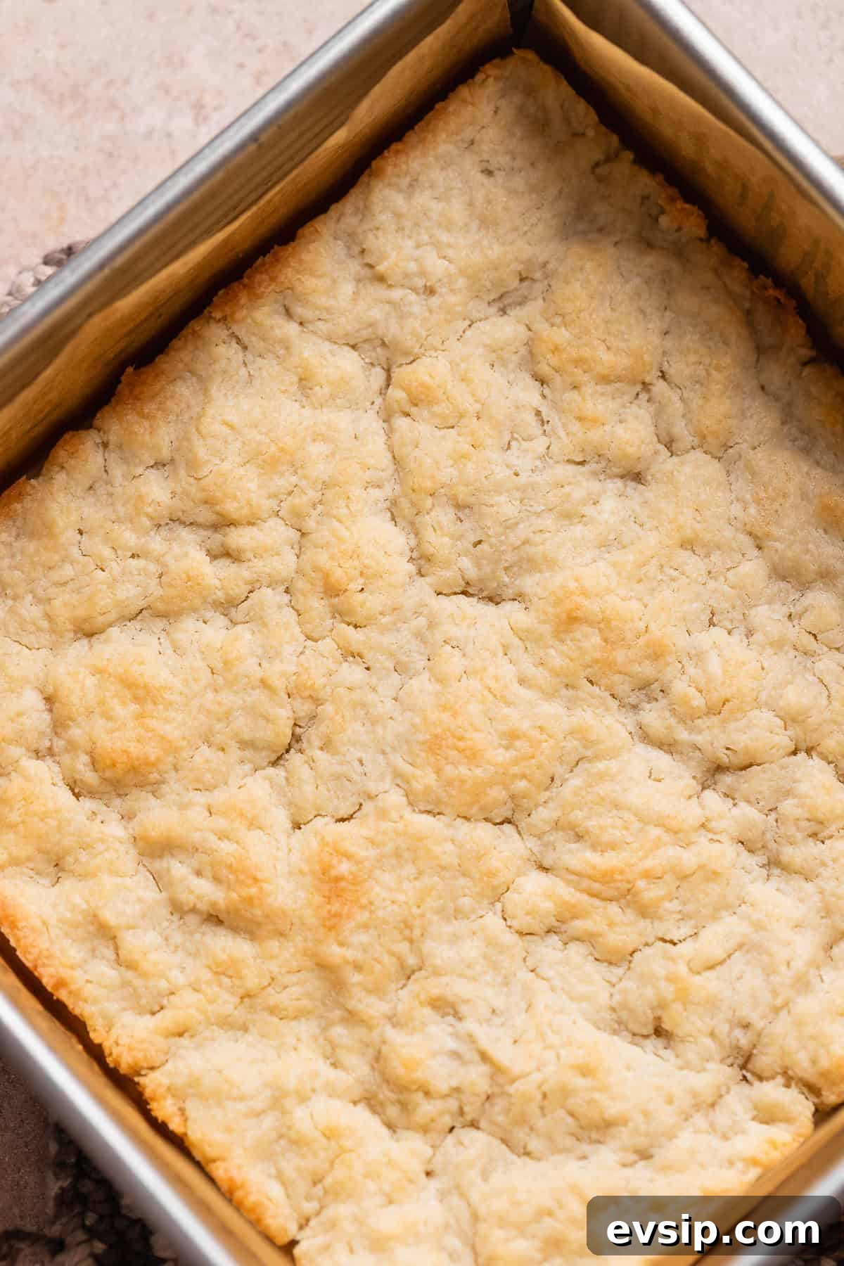 The baked pie dough crust with golden brown edges in a baking pan.