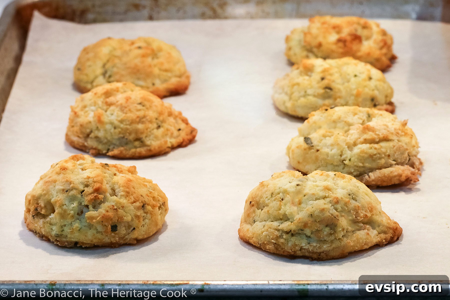 White plate with golden brown drop Easy Cream Biscuits set on a deep blue napkin and black background © 2023 Jane Bonacci, The Heritage Cook.
