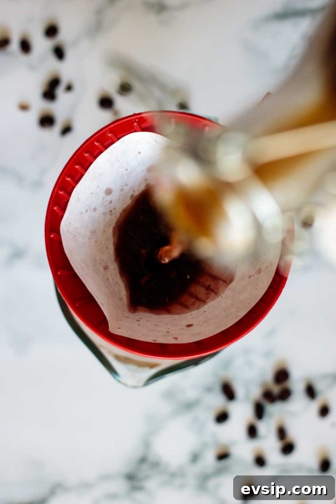 Cold Brew Coffee Concentrate: Ratios, Methods & Pro Tips 11 pouring cold brew through paper filter