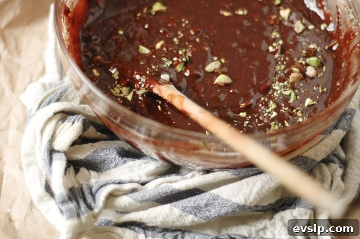 A gooey, fudgy-bellied, gluten-free brownies recipe. Each delicious, gluten-free flourless brownie is studded with shards of macadamia nuts and pistachios. | sophisticatedgourmet.com