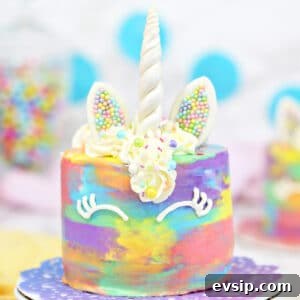Piñata Cake Recipe with Video: Step-by-Step Guide 9 Close up of a unicorn cake on a colorful doilie.