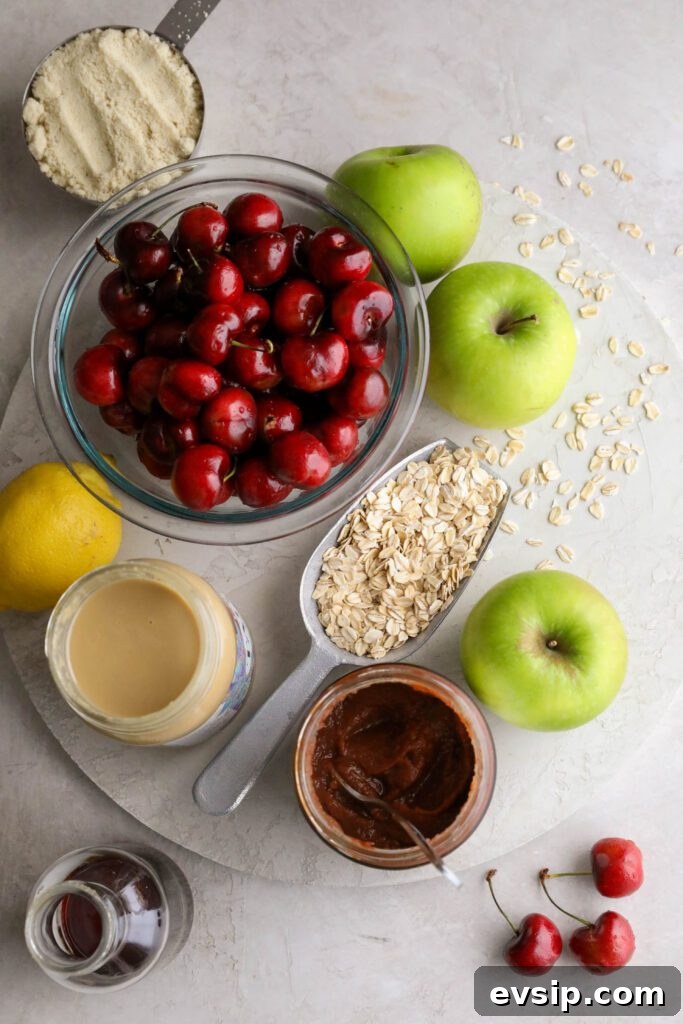 Apple Cherry Tahini Crumble Recipe — Rustic Fruit Dessert 3 apples, cherries, oats, apple butter, tahini, maple syrup, lemon, and almond flour on board