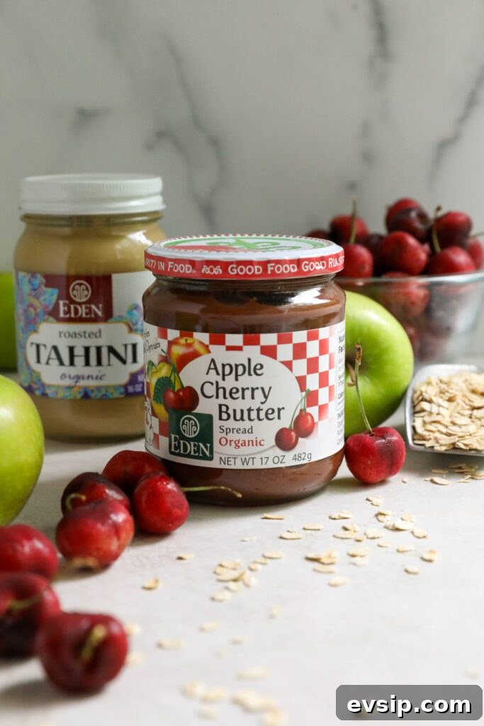 Apple Cherry Tahini Crumble Recipe — Rustic Fruit Dessert 4 Apple Cherry Butter and Tahini on board surrounded by cherries and apples
