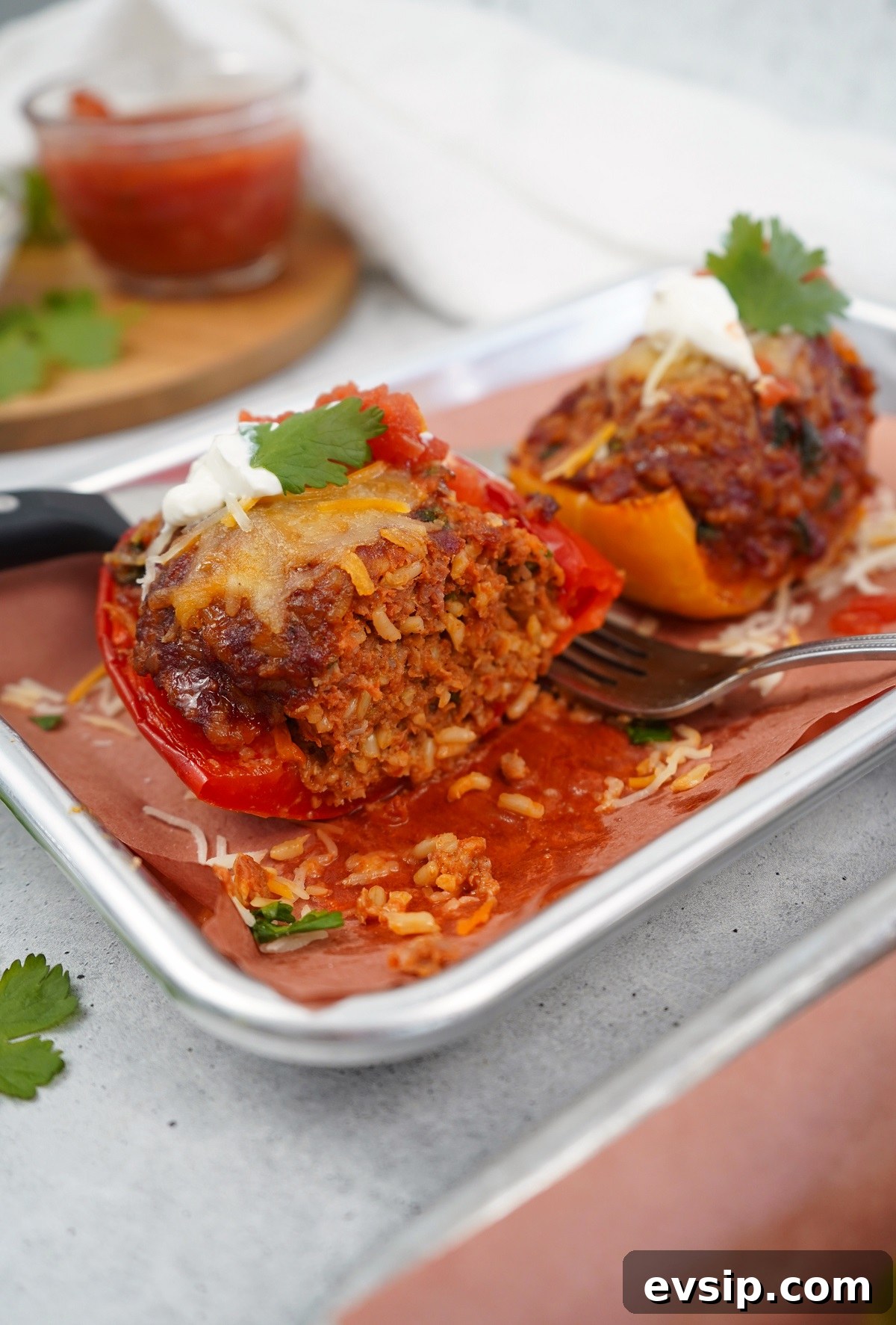 Smoked chorizo stuffed peppers with fork. 