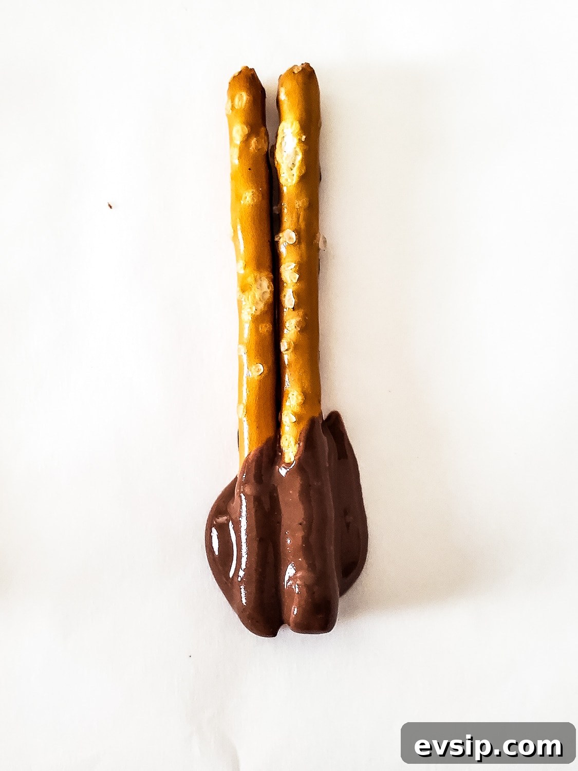 dipped pretzels drying on parchment