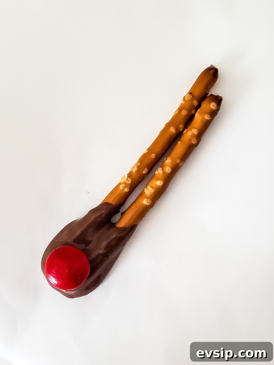 two pretzel rods with red m & M