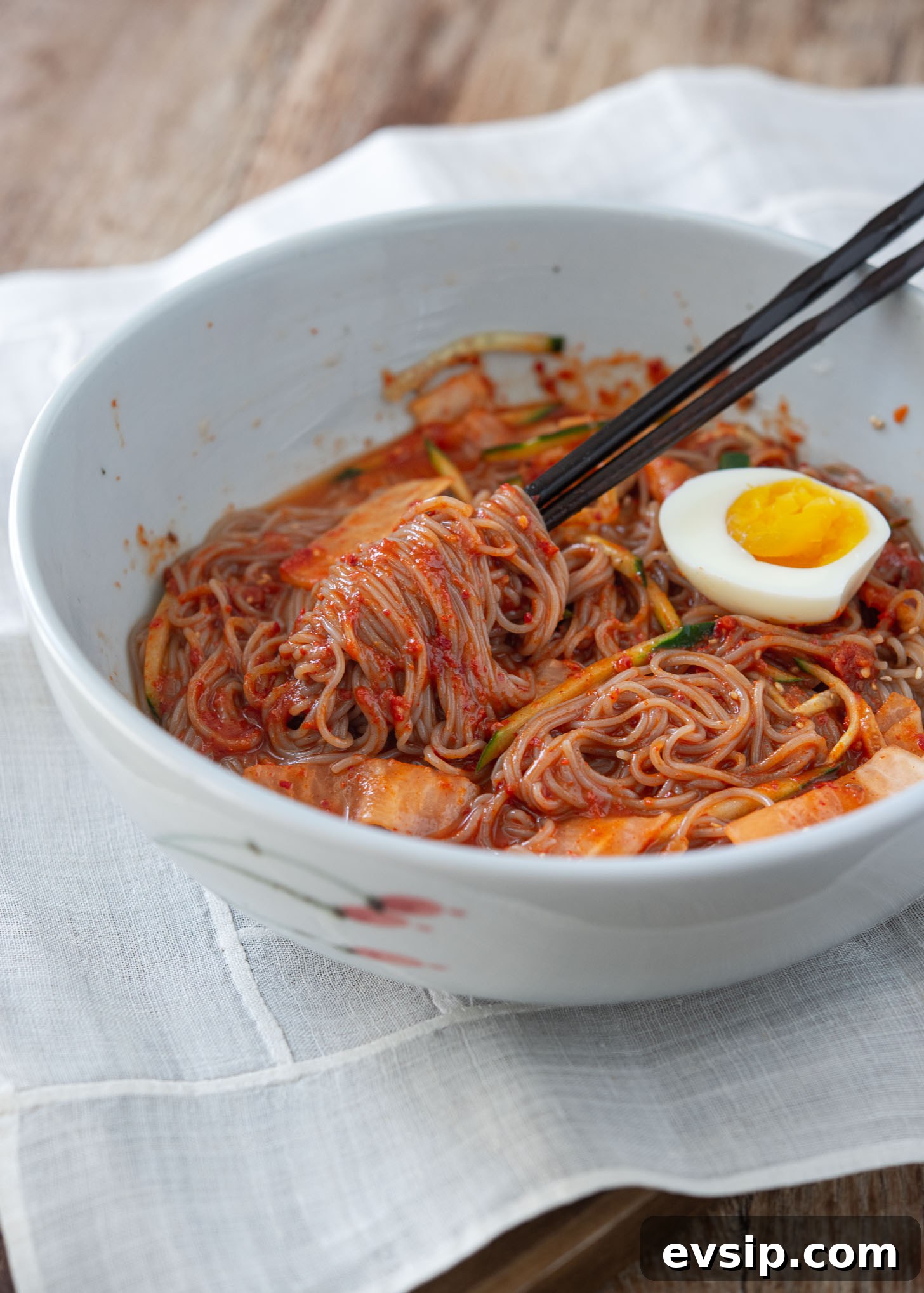 Spicy cold buckwheat noodles fully mixed with sauce, ready to serve.