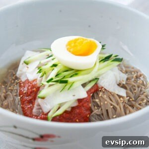 Korean naengmyeon cold noodles with spicy bibim sauce, cucumber, and egg