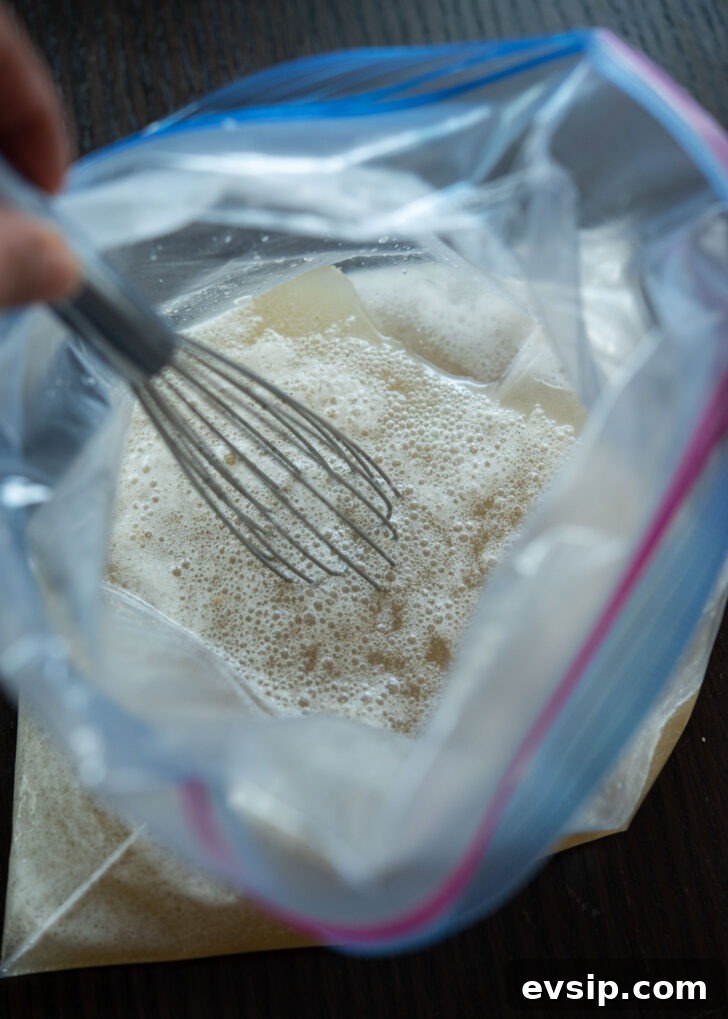 Quick naengmyeon beef broth mixture in a zip-top bag, ready to freeze for slushy consistency.