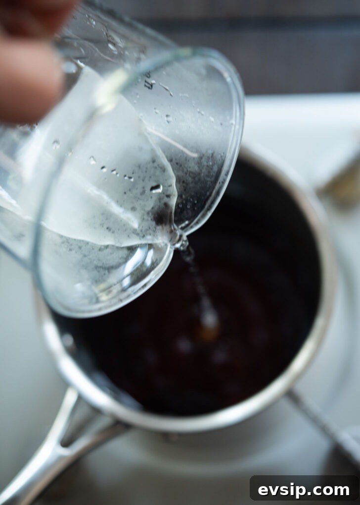 Soy sauce and water mixture simmering in a pot as the base for bibim naengmyeon sauce.