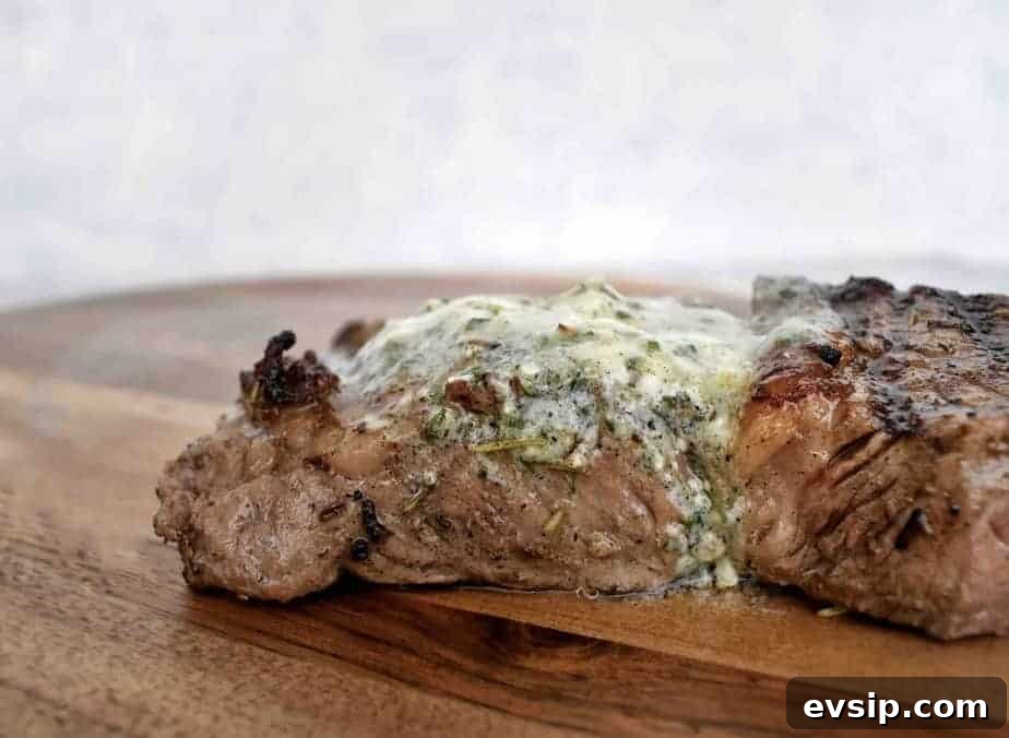 Blue Cheese Compound Butter Recipe for Steak, Vegetables & Bread 2 bleu cheese butter melted over the top of a grilled steak on a wooden board