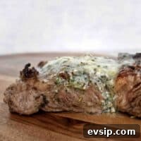 steak on wooden board with butter on top