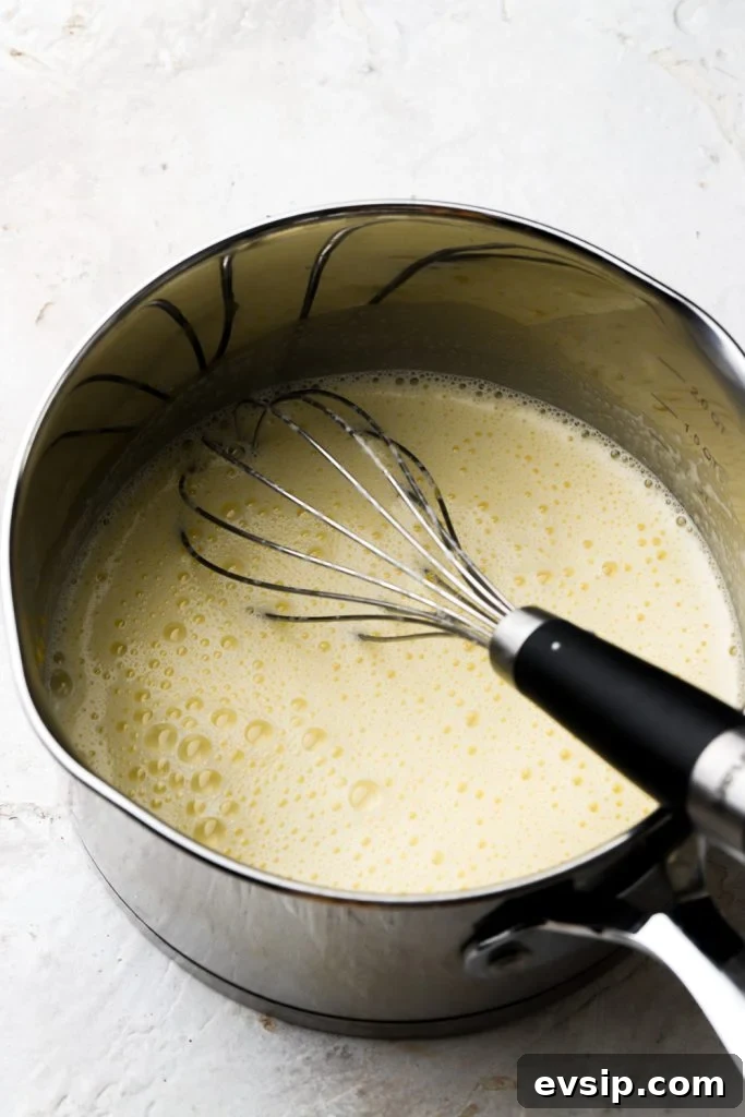 Banana Pudding Cheesecake Recipe with Creamy Layered Filling 16 eggs tempered with milk in saucepan
