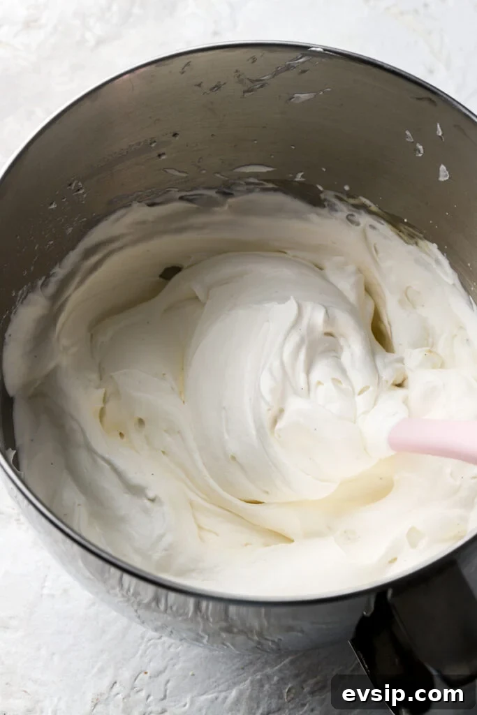 Banana Pudding Cheesecake Recipe with Creamy Layered Filling 21 finished chantilly cream in a bowl