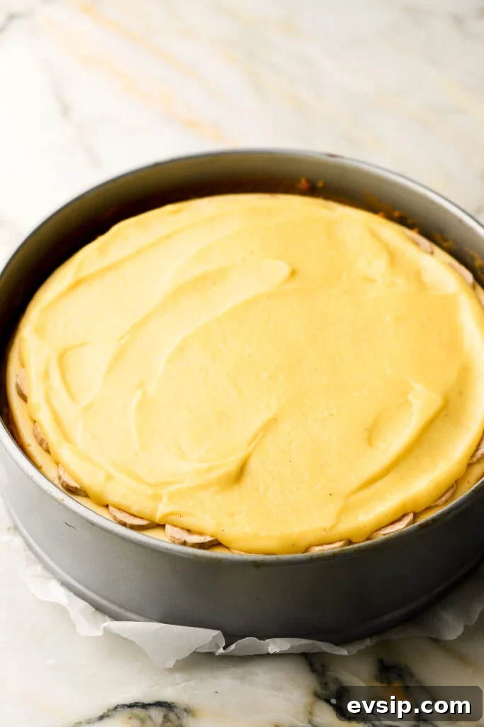 Banana Pudding Cheesecake Recipe with Creamy Layered Filling 23 pastry cream on top of banana slices