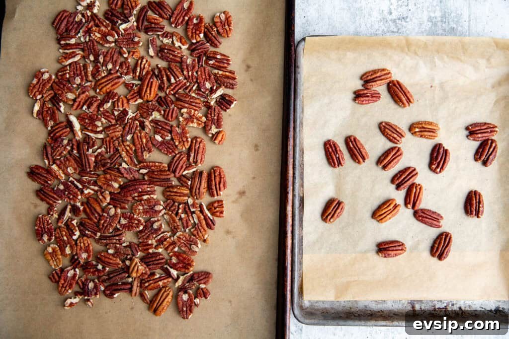 pecans toasting on a baking sheet