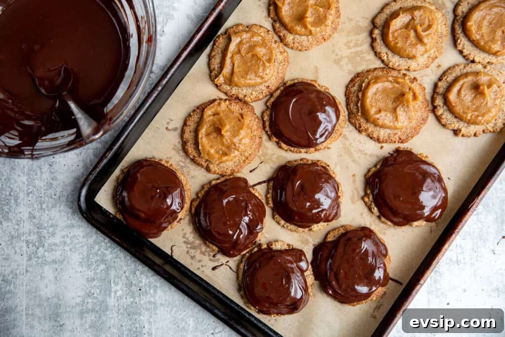 spooning carmel and chocolate onto the cookie base