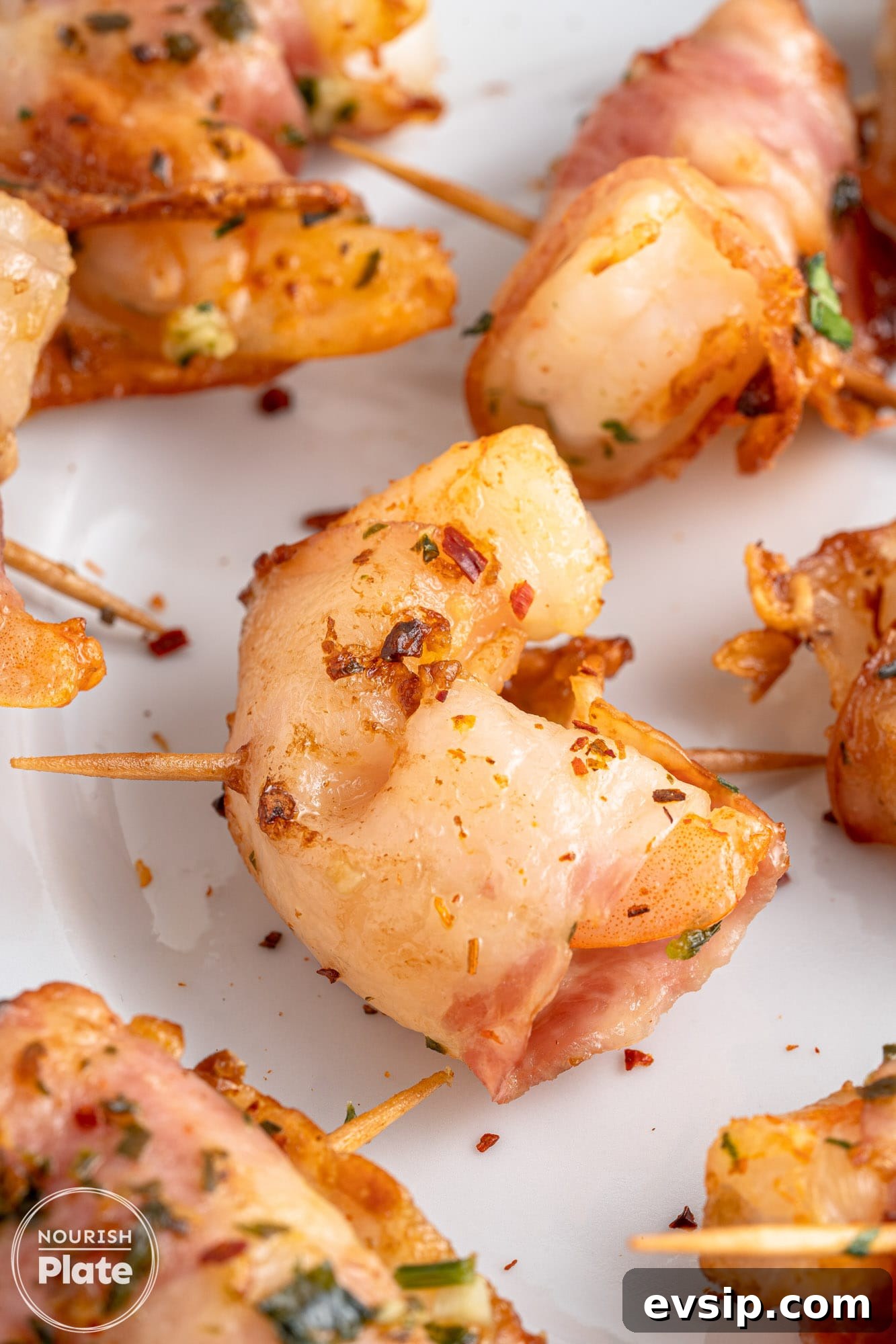 Close up shot of bacon wrapped shrimp, sealed with skewers