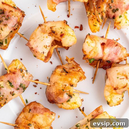 Overhead shot of bacon wrapped shrimp on a white plate