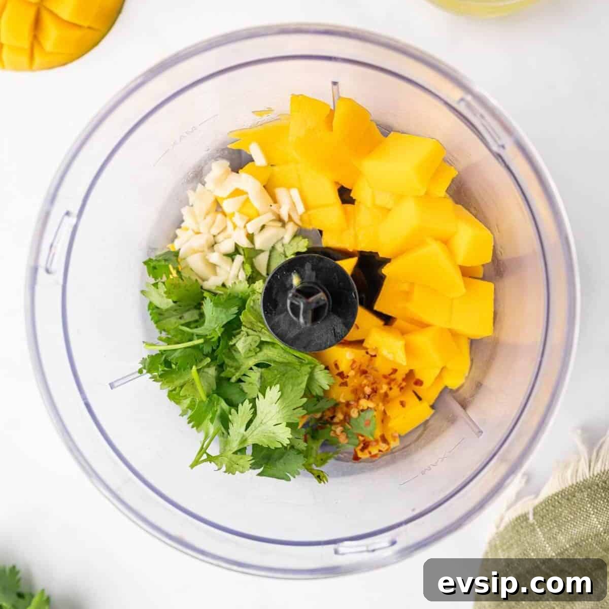 Preparing the mango salad dressing in a food processor.