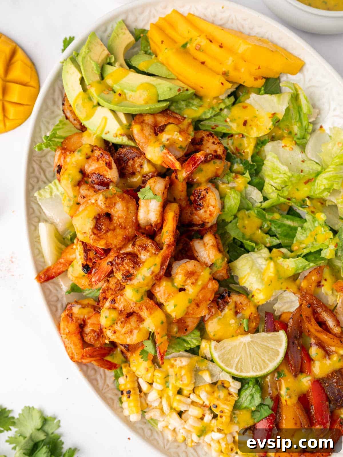 Shrimp salad with mango arranged on a platter.