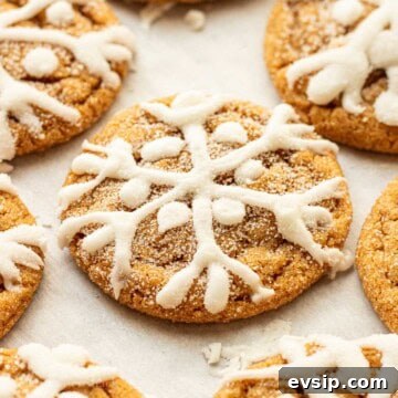 Baked iced molasses cookies on baking sheet.