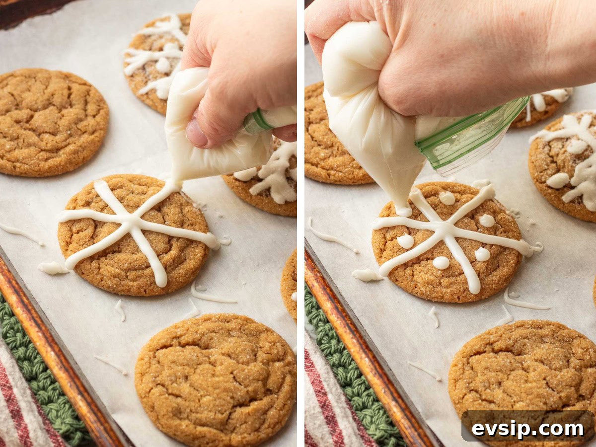 Hand holding icing bag piping icing onto chewy molasses cookies.