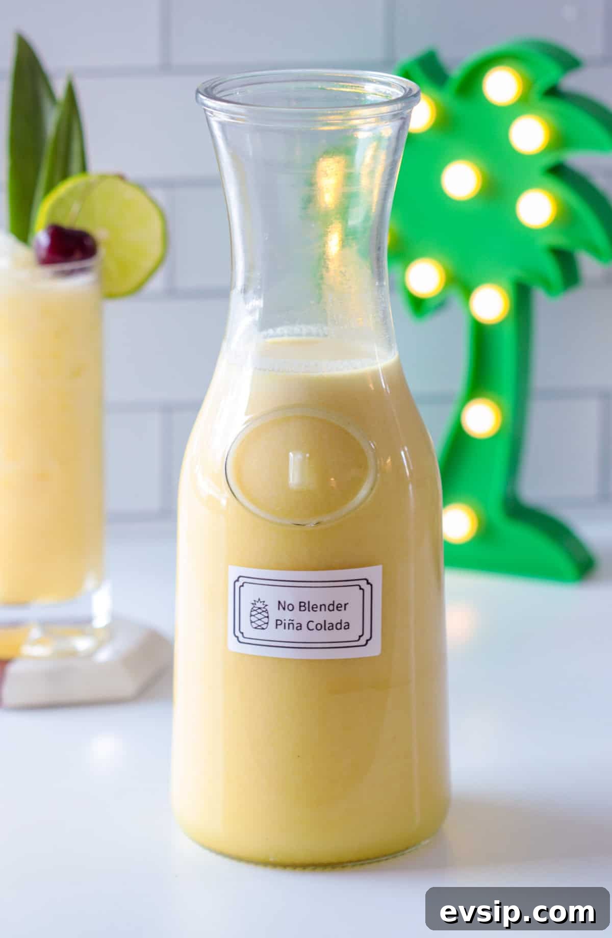Pina colada in a pitcher with a label.