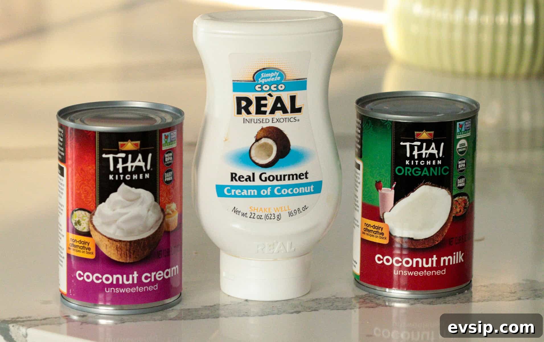 Coconut cream, coconut milk and cream of coconut on counter.