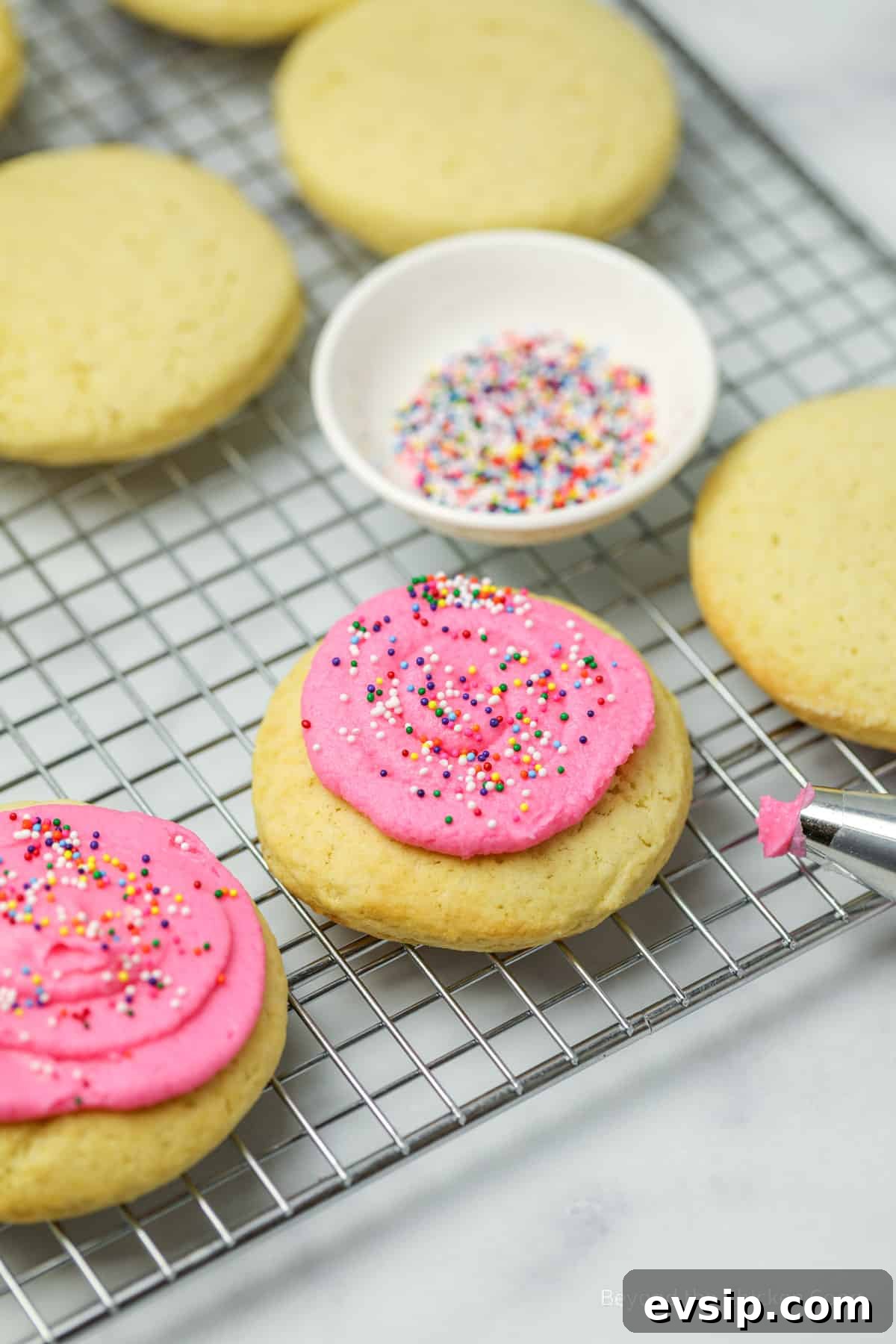 Lofthouse Cookie Recipe: Soft Frosted Sugar Cookies Guide 8 Frosting cookies with pink frosting.