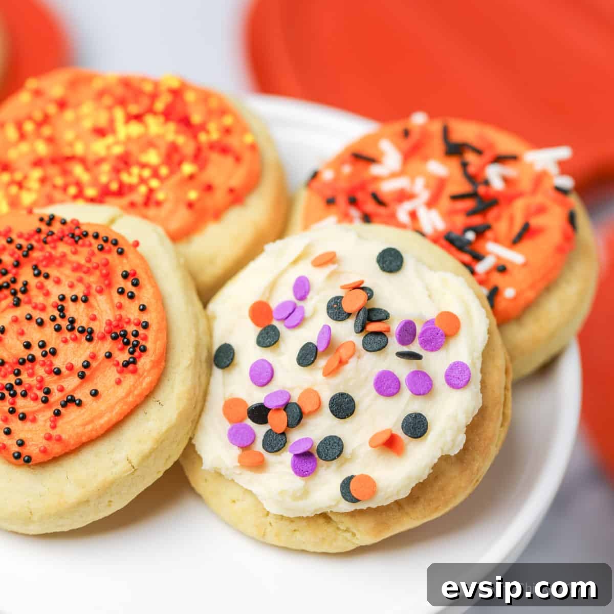Lofthouse Cookie Recipe: Soft Frosted Sugar Cookies Guide 9 Halloween lofthouse cookies on a white cake stand.