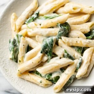Creamy Boursin Pasta Recipe with Garlic and Herbs 6 close-up of creamy Boursin pasta with spinach in a shallow bowl