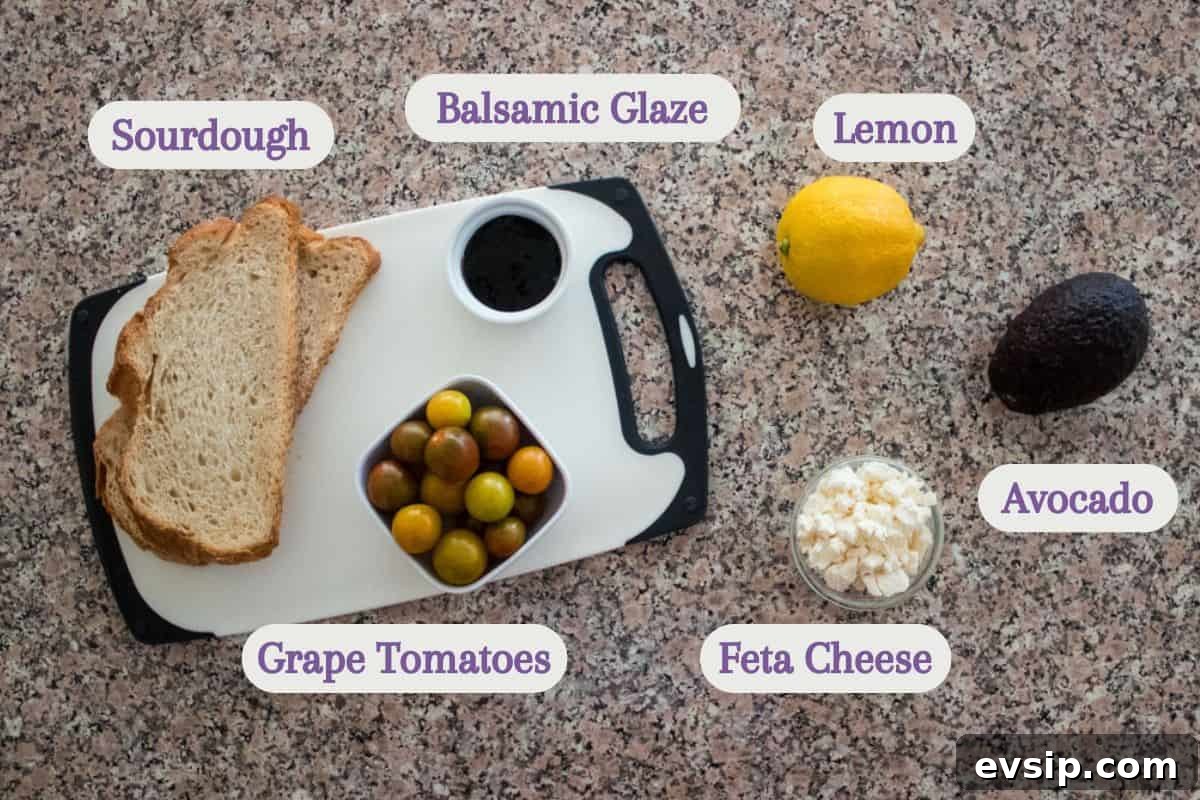 Top-down view of ingredients on a countertop: slices of sourdough, a bowl of grape tomatoes, balsamic glaze, a lemon, an avocado, and a bowl of feta cheese, each labeled with text.