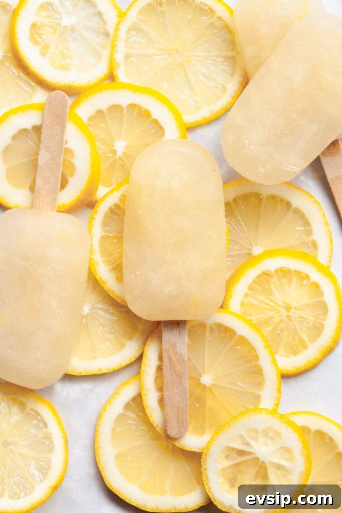 Easy lemonade popsicles recipe made with 3 ingredients and naturally sweetened with honey.