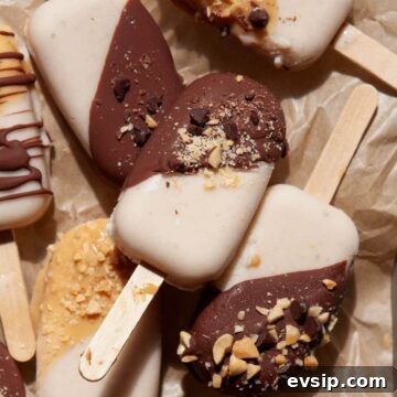 Healthy banana popsicles made with Greek yogurt and topped with a homemade chocolate magic shell.