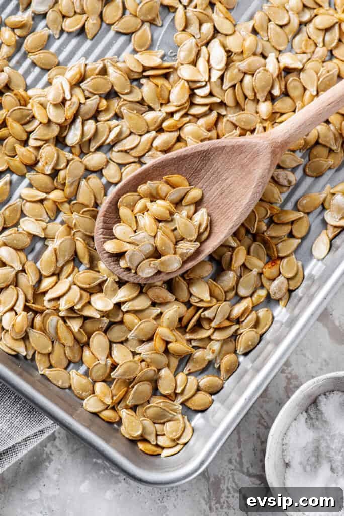 Crunchy Oven-Roasted Pumpkin Seeds for Snacking and Baking 5 roasted pumpkin seeds in a white bowl