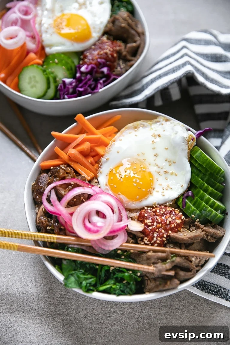 Korean Beef Bibimbap Recipe: Authentic Mixed Rice Bowl 6 Easy bibimbap recipe with korean beef, cooked spinach, cooked mushrooms, and fried egg on top.