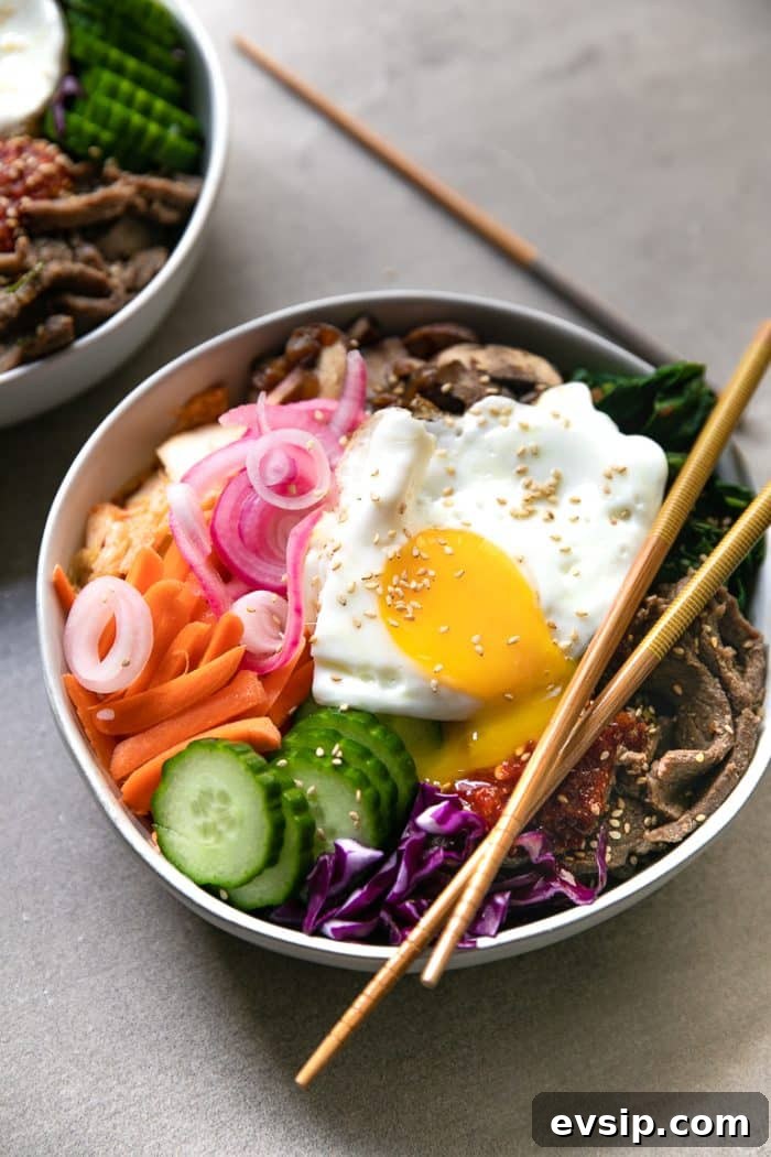 Korean Beef Bibimbap Recipe: Authentic Mixed Rice Bowl 7 A bowl of food on a plate, with Beef and Bibimbap